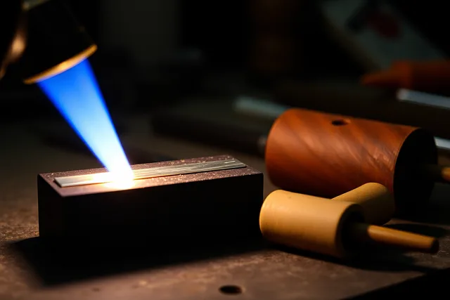 Torch annealing a silver strip on a soldering block before band forming. How to anneal and form a silver band in controlled stages