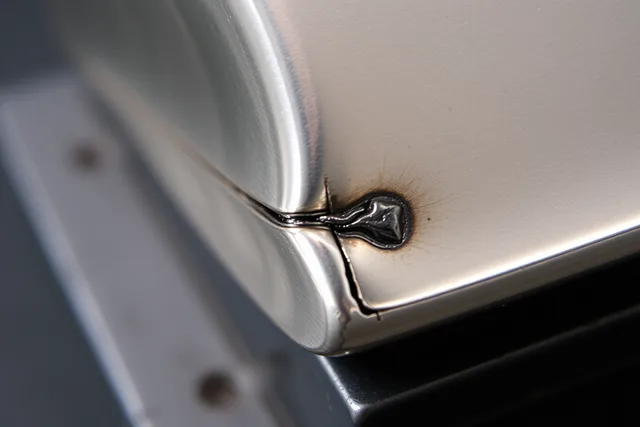 Failed sterling-silver box seam with dark central gap and solder pool beside joint. Diagnosing a failed sterling-silver box seam case